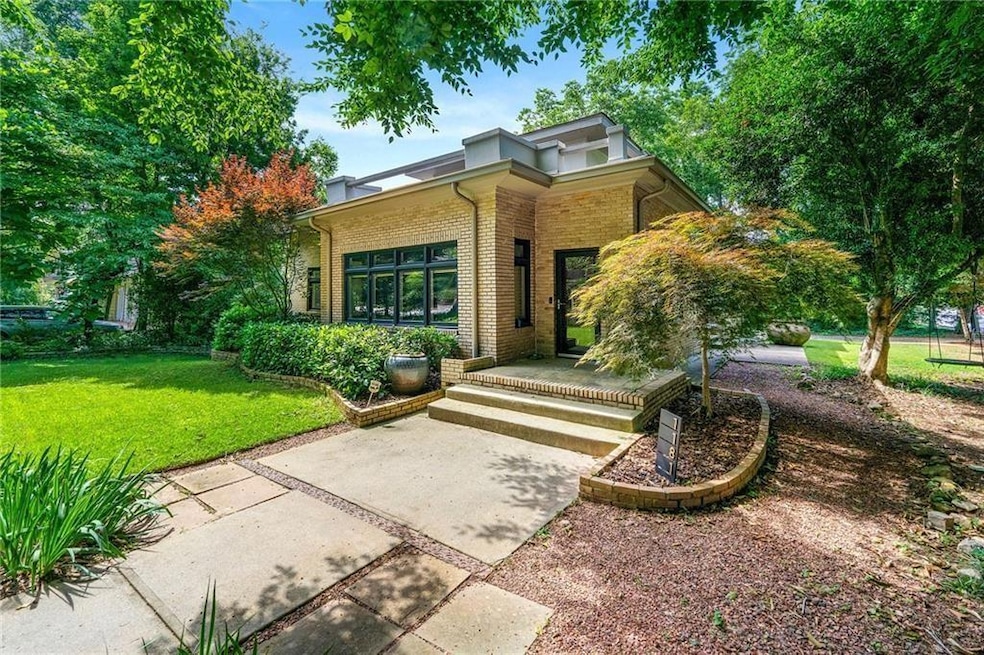 View of front of house with a front yard and brick siding