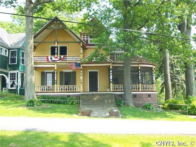 Exterior Front. Open and screened porches face the