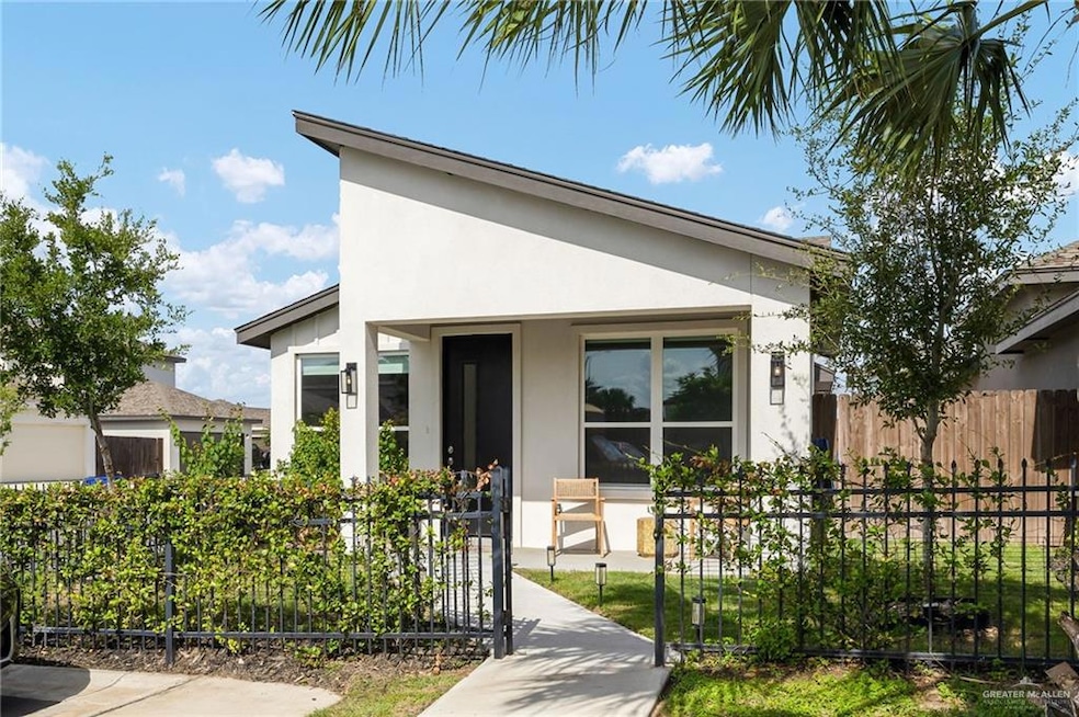 View of front of house with stucco siding and covered porch