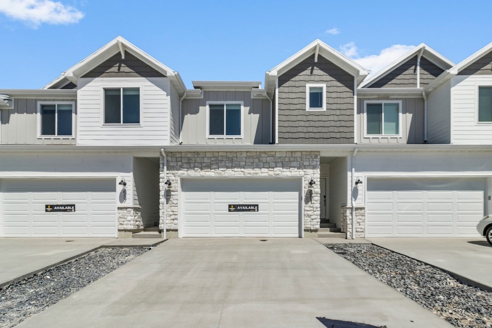 Craftsman inspired home with stone siding, board and batten siding, and concrete driveway