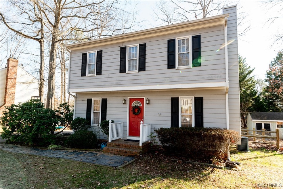 View of front of home with a front lawn and central air condition unit