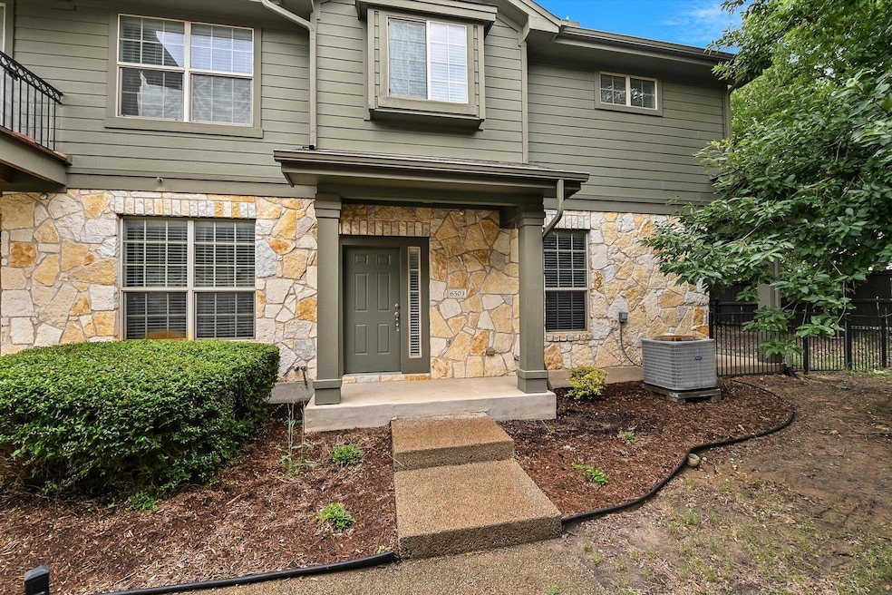 Entrance to property featuring stone siding