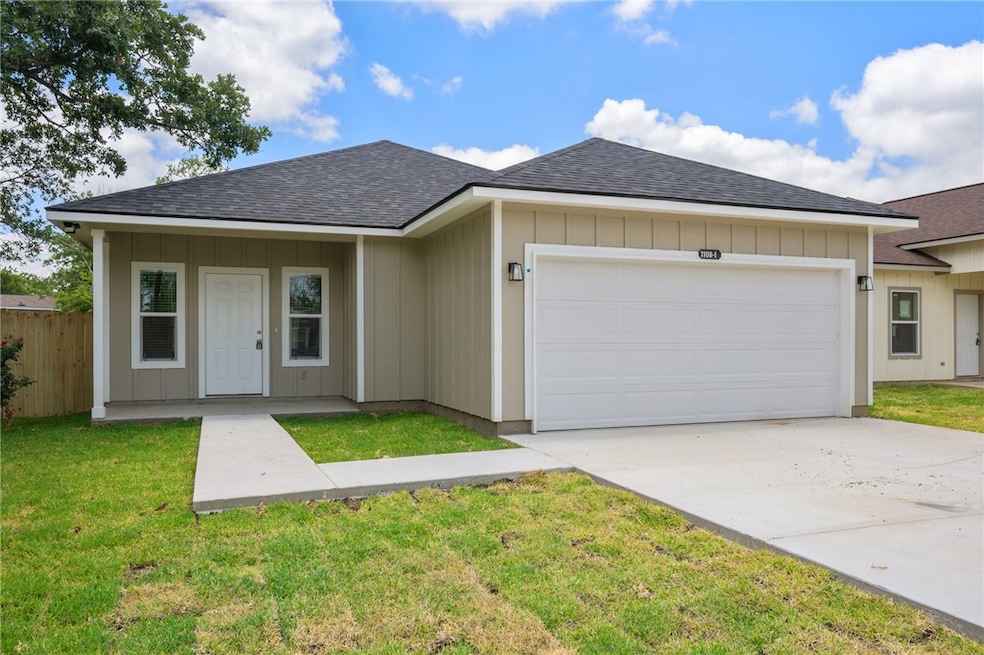 Ranch-style house with a shingled roof, a garage,