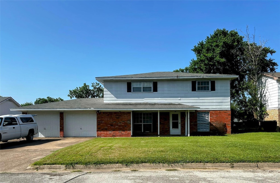 Traditional home featuring a garage, brick siding