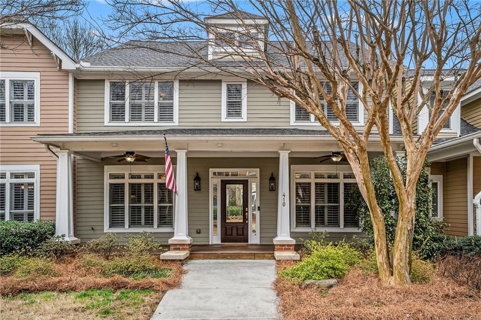View of front of house with ceiling fan and a porc