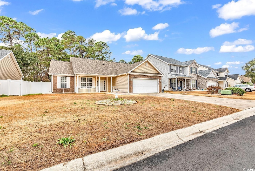 View of front of house with a garage and covered p