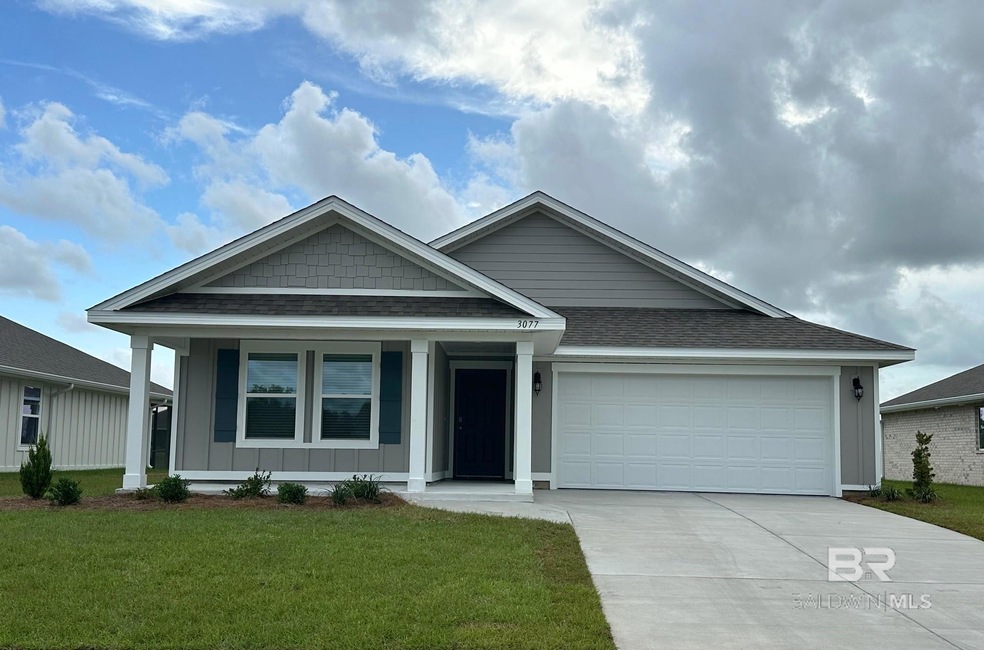 View of front of house featuring a front lawn and a garage