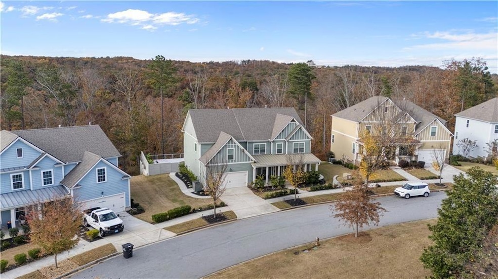 Aerial view of residential area featuring a heavily wooded area