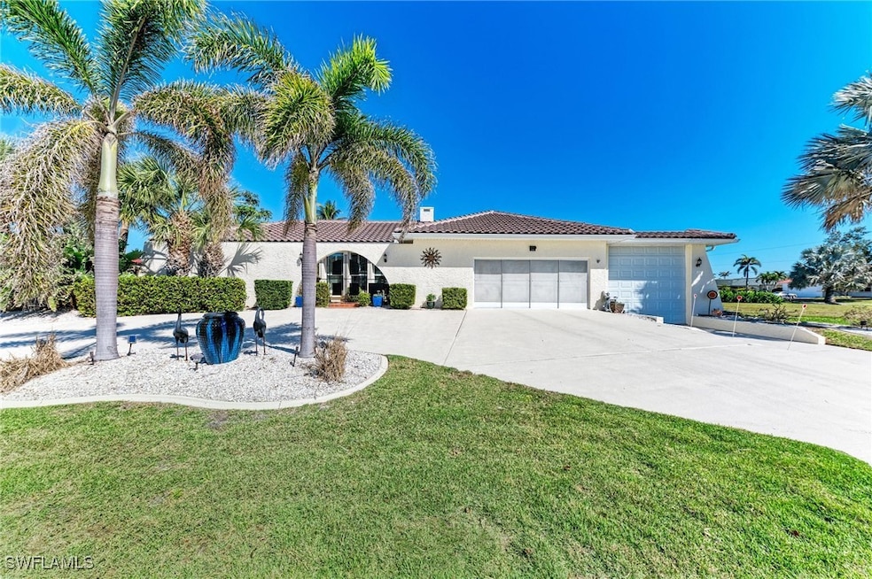 View of front facade with a front yard, driveway,
