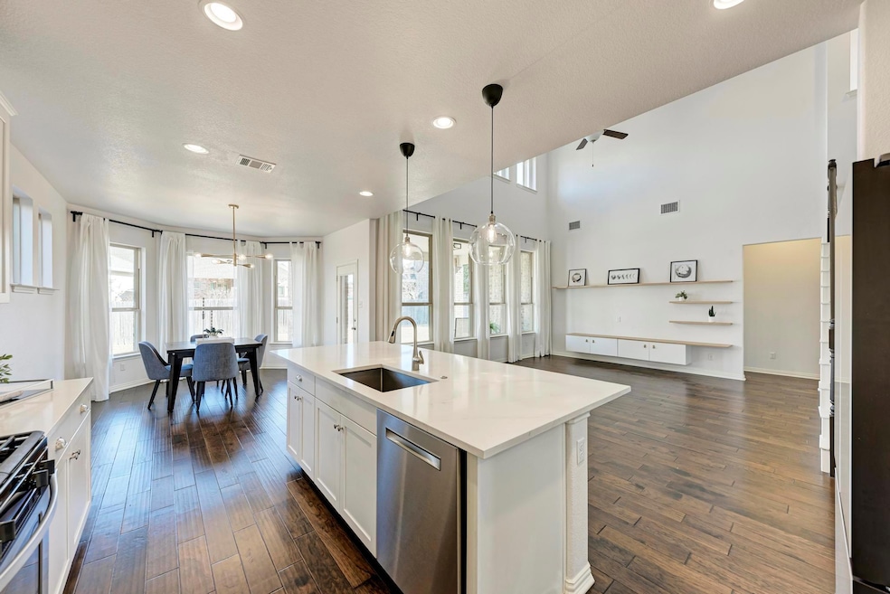 Kitchen with visible vents, dishwasher, gas range