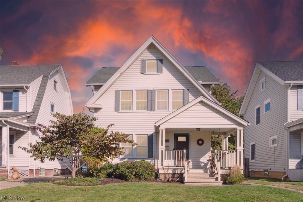 View of front of house featuring a yard and covered porch