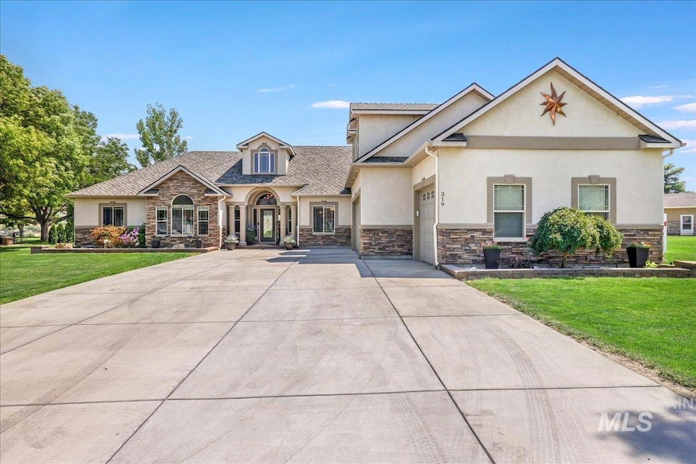 View of front of house with stone siding, stucco siding, a front lawn, and concrete driveway