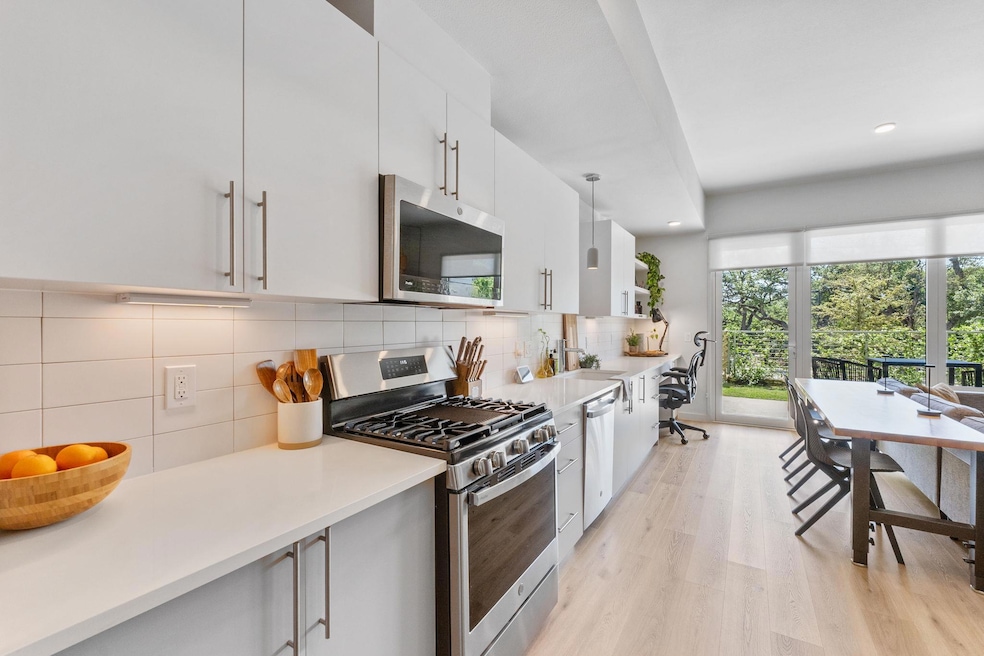 Kitchen featuring stainless steel appliances, bac