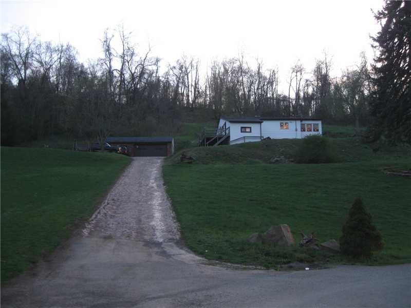 Exterior Front. House with driveway and  Block gar