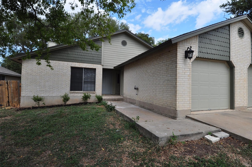 Ranch-style house with brick siding, an attached 