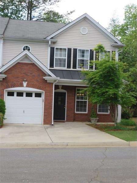 Beautiful brick front townhome with large side yar