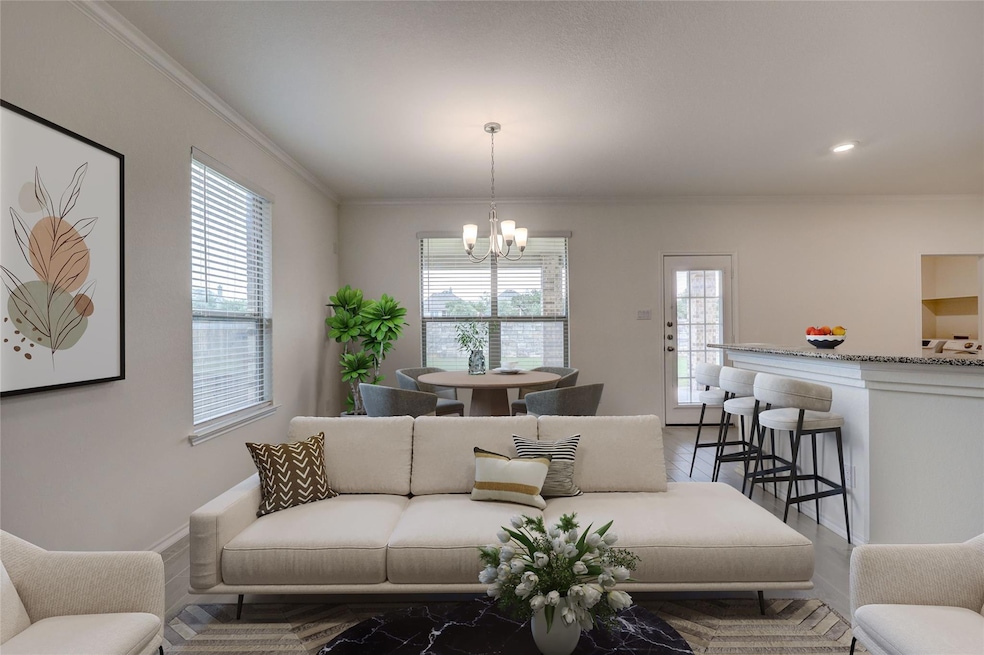 Living room featuring a chandelier and ornamental