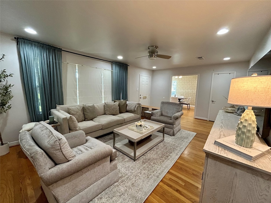 Beutiful living area with hardwood floors and recessed lighting.