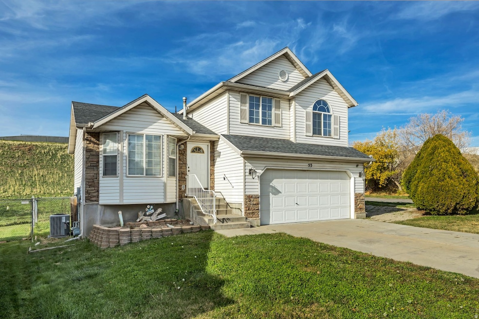 View of front of property with an attached garage, driveway, and a shingled roof
