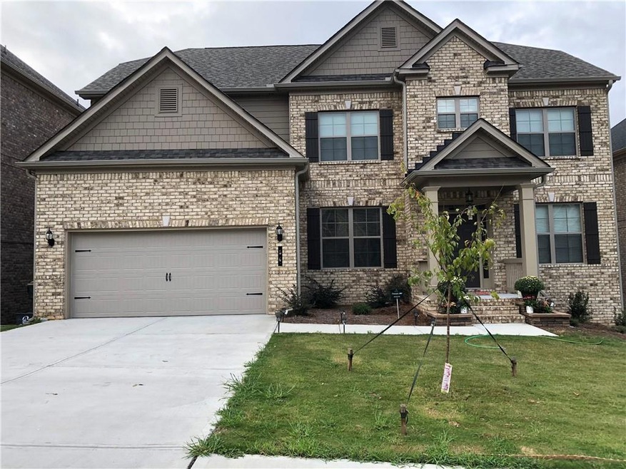 Craftsman house with a garage and a front lawn
