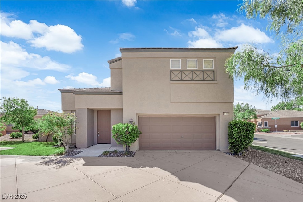 View of front of home featuring a garage, stucco siding, and driveway
