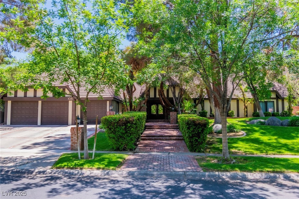 Tudor house with stucco siding, a front yard, and