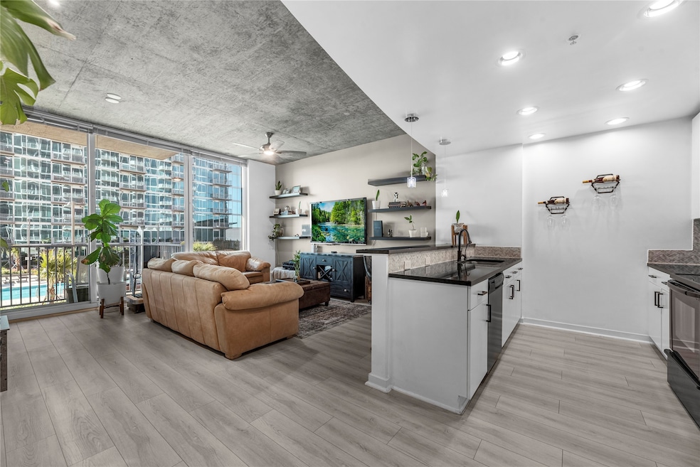 The open-concept living space features minimalist