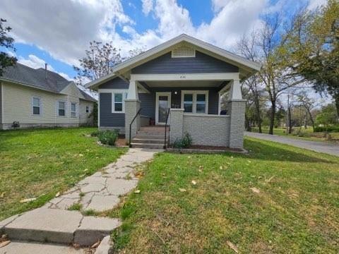 Bungalow-style house featuring a front lawn