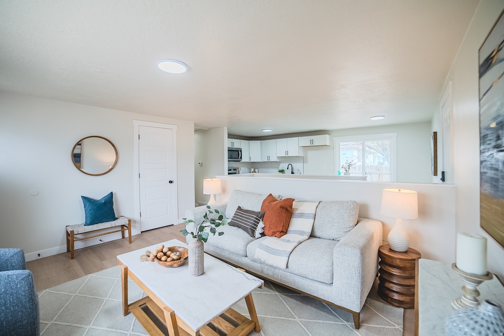 Living room featuring light wood-style flooring and recessed lighting