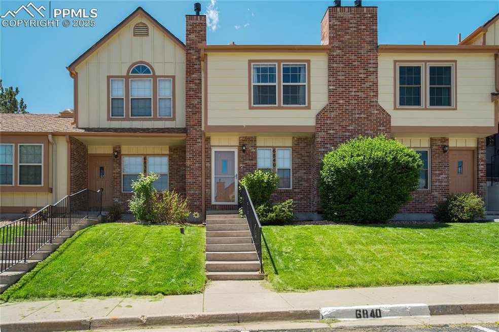 Multi unit property featuring a chimney, brick sid