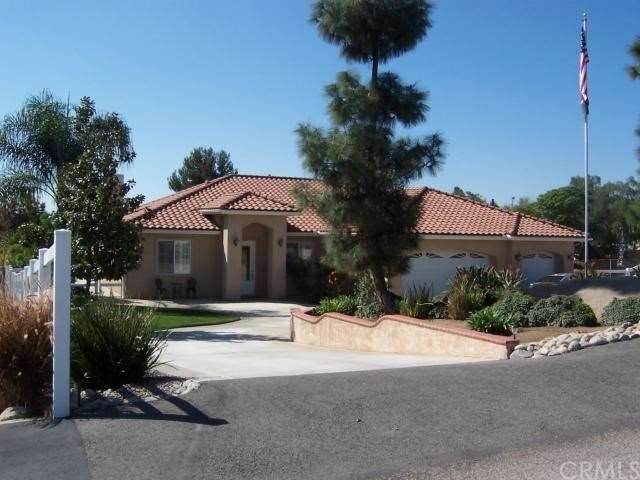 Front of home with Large circular driveway