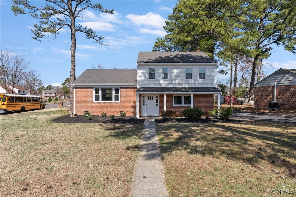 View of front facade featuring brick siding, a chi