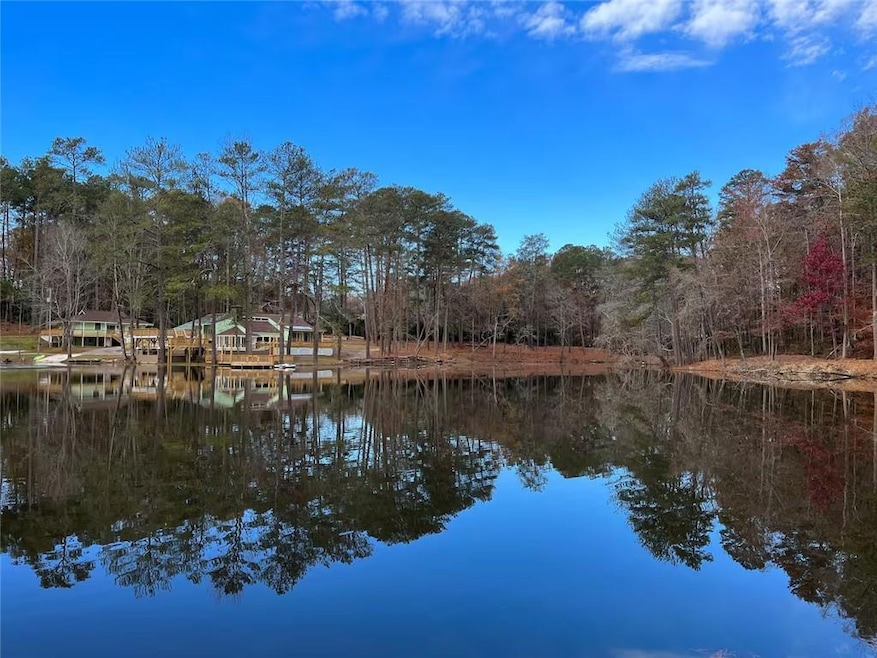 Beautiful water view of private lake with wooded shoreline and peaceful natural surroundings.