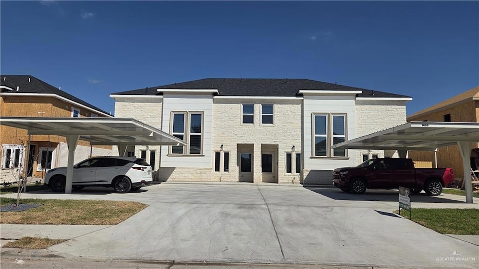 View of front of house with stone siding and covered parking