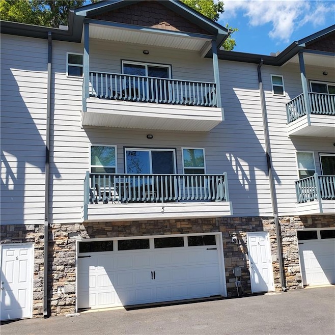 View of property with a balcony and a garage