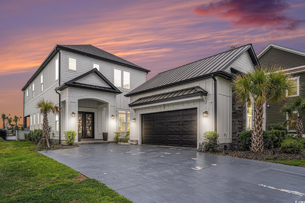 View of front of home featuring driveway, a standi