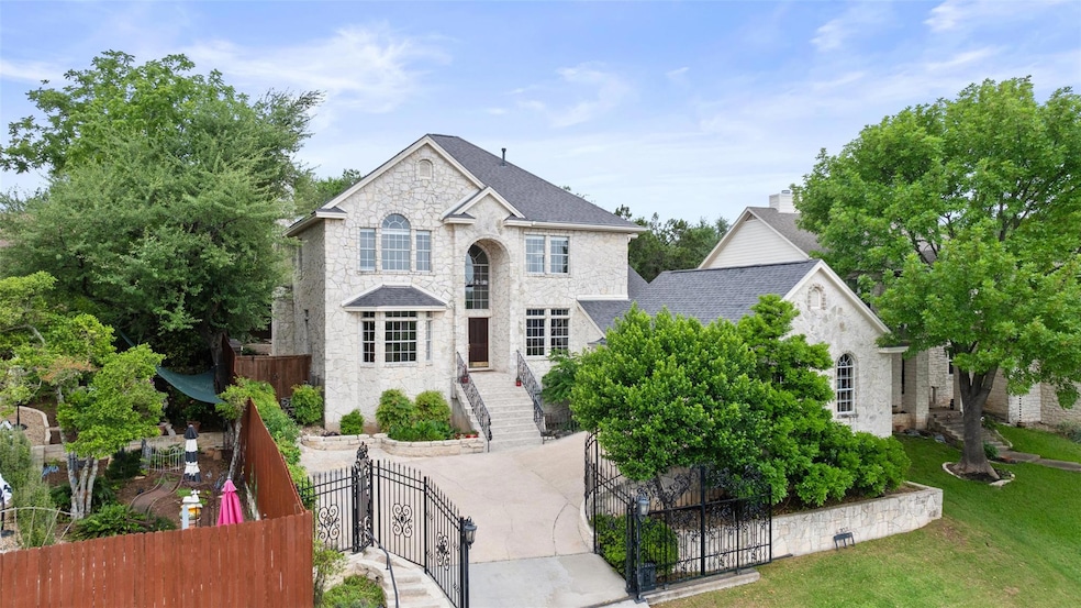 View of front of property featuring a gate, stone