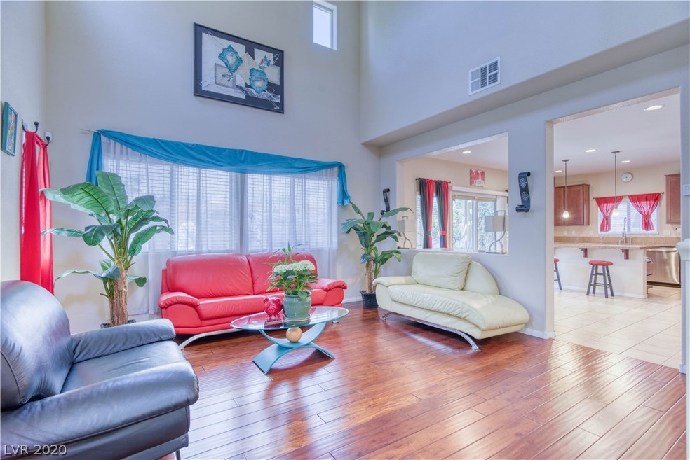 Open airy family room with soaring ceilings and wo
