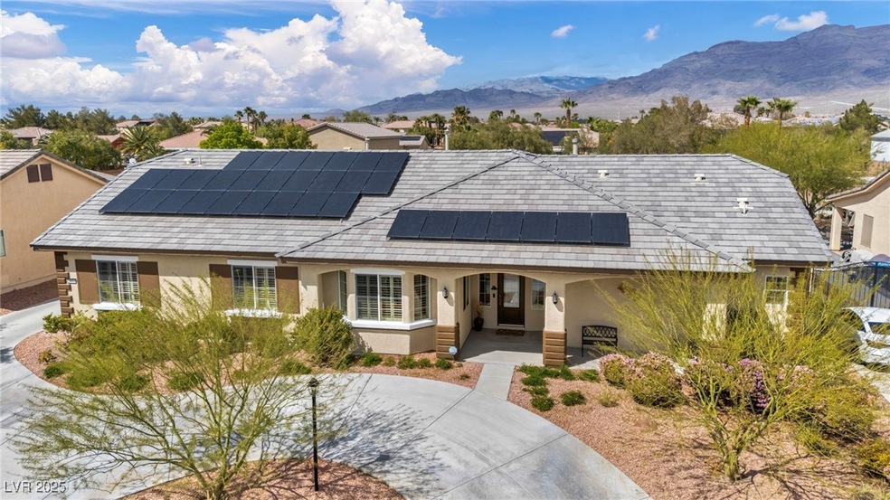 View of front facade with solar panels, stucco sid
