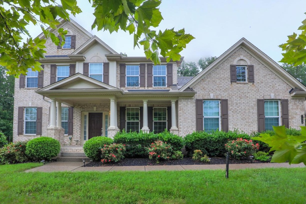 Elegant brick home with front porch. Shutters with all the detailed hardware. Sidce entry garage.