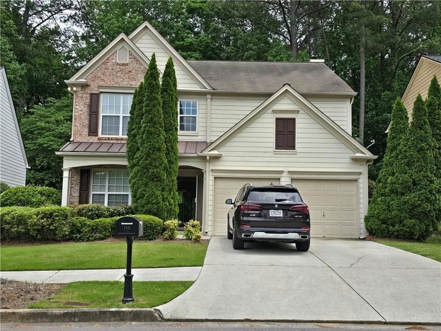 View of front of home featuring a garage and a front lawn