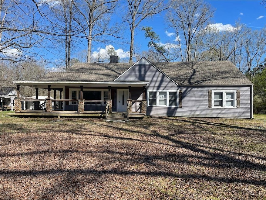 View of front facade with a chimney, a porch, and 