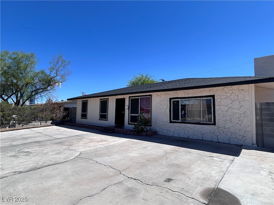 Back of property featuring a patio and roof with s