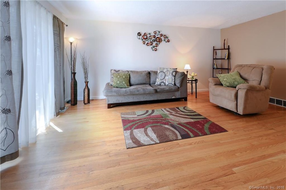 Spacious, bright living room with hard wood floors