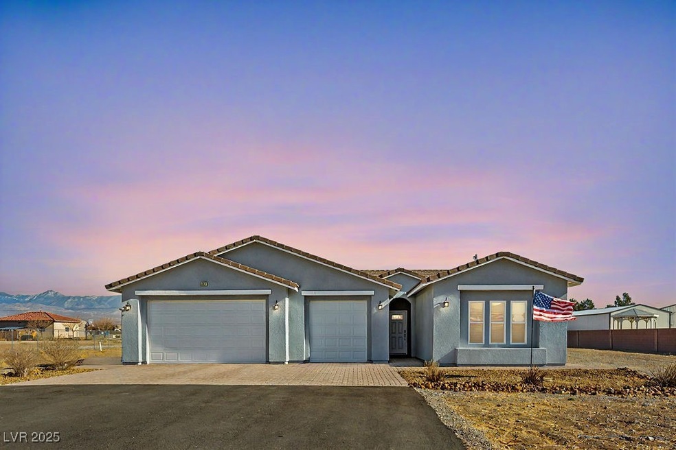 Ranch-style house featuring stucco siding, an atta