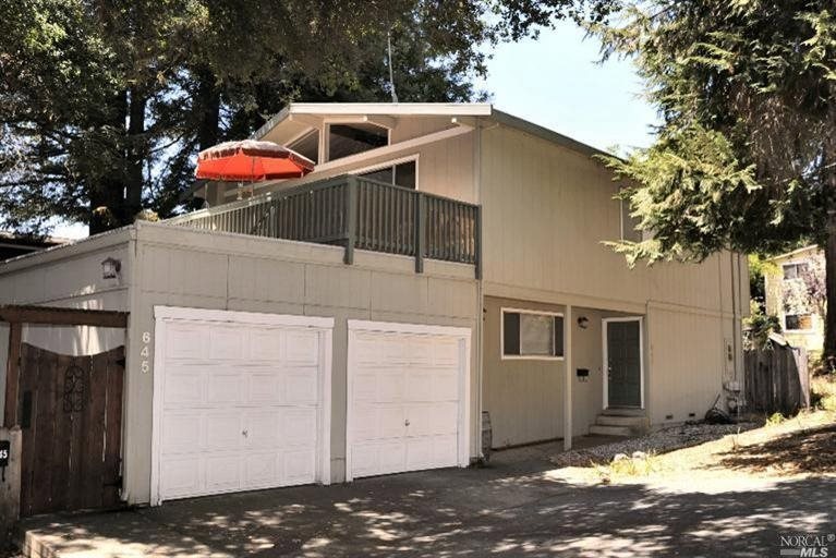 Front view of duplex and garages