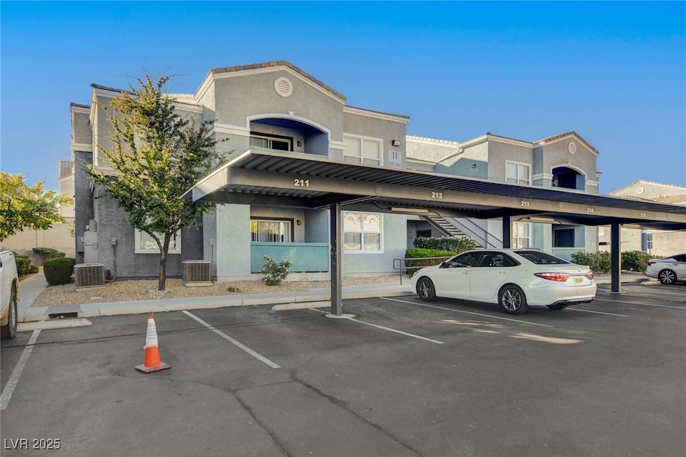 View of building exterior featuring covered parking