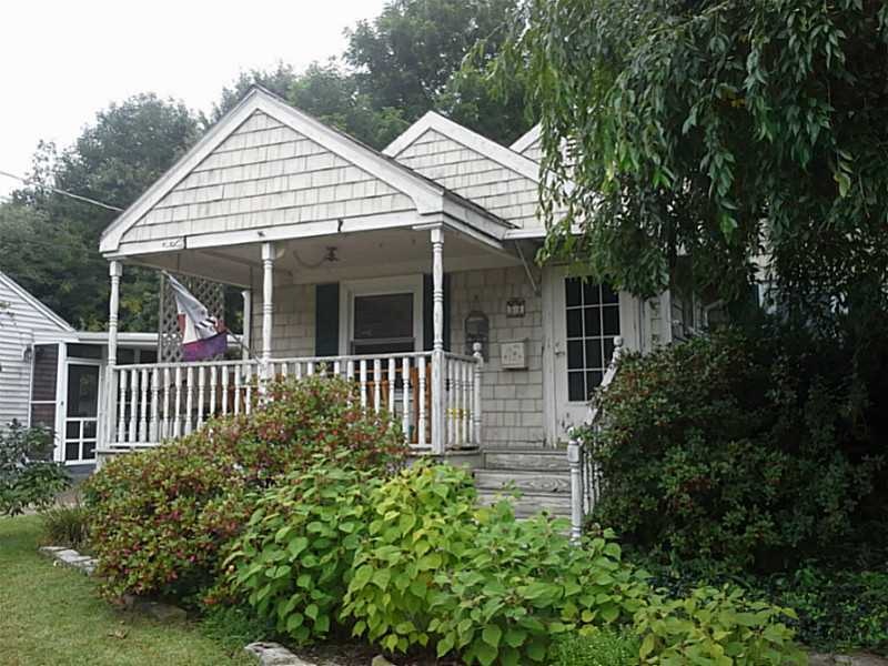 Exterior Front. Spacious porch with swing and land