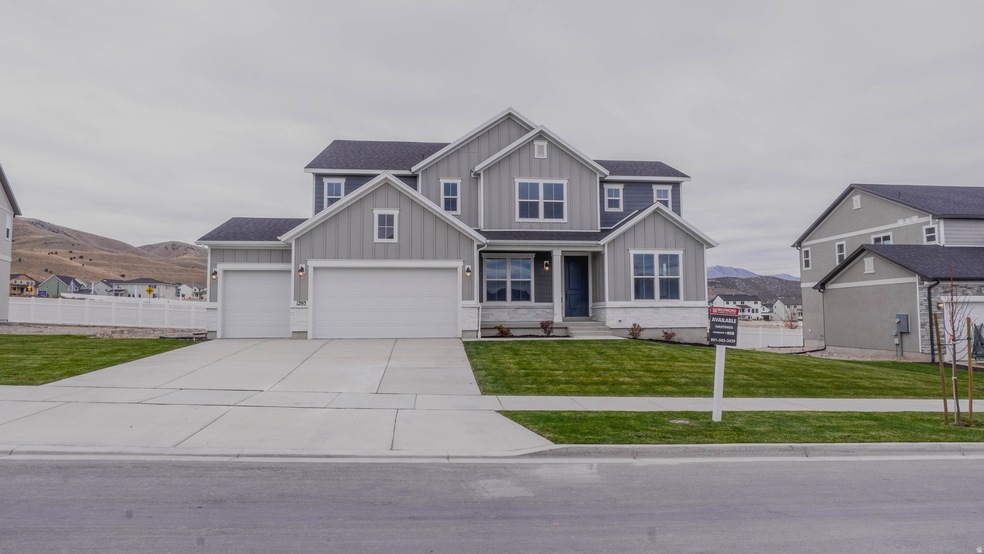 Craftsman house featuring board and batten siding, concrete driveway, a mountain view, and roof with shingles
