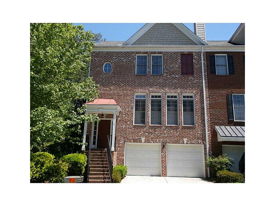 Exterior Front. Stately brick end unit with two ca